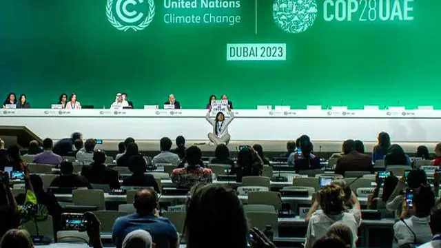 Aktivis melakukan protes di atas panggung menentang bahan bakar fosil dalam acara Konferensi Iklim PBB (COP28) di Dubai pada 11 Desember 2023. (AFP/AFPTV)