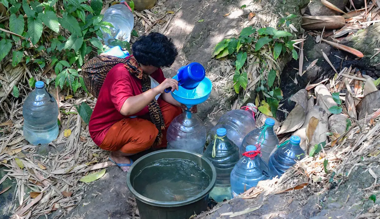 Penyandang tunanetra, Sujanah,mengambil air pada  mata air Sumur Bendung di kawasan Gunung Batur, Kota Cilegon, Banten, Minggu (19/07/2026). (KLY/Arie Basuki)