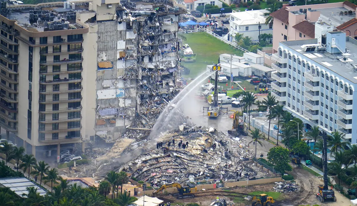 Petugas penyelamat bekerja di puing-puing Champlain Towers South Condo, Surfside, Miami, Florida, Amerika Serikat, Jumat (25/6/2021). Penyebab runtuhnya gedung berusia 40 tahun itu masih belum diketahui secara jelas. (AP Photo/Gerald Herbert)
