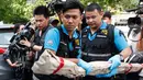 Petugas forensik Thailand membawa barang bukti usai ledakan bom di Rumah Sakit Phramongkutklao, Bangkok. (22/5). (AP Photo / Sakchai Lalit)