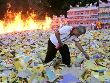 Seorang pria etnis Tionghoa membakar uang arwah saat festival Hungry Ghost atau Hantu Kelaparan di Medan, Sumatera Utara (5/9). Di Indonesia festival ini lebih dikenal dengan perayaan Zhong Yuan. (AP Photo/Binsar Bakkara)