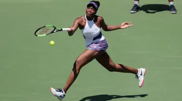 Unggulan delapan Venus Williams mengembalikan bola ke arah petenis Belanda, Kiki Bertens pada hari ketujuh turnamen Miami Terbuka di Crandon Park, Minggu (25/3).  Venus susah payah lolos ke babak 16 besar dengan skor 5-7, 6-3, 7-5. (AP/Lynne Sladky)