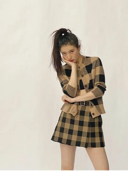 Gaya Suzy juga bisa menjadi inspirasimu nih, ia mengenakan cardigan dan mini skirt dengan motif dan warna serupa yaitu geometris cokelat. Dok. Instagram @skuukzky