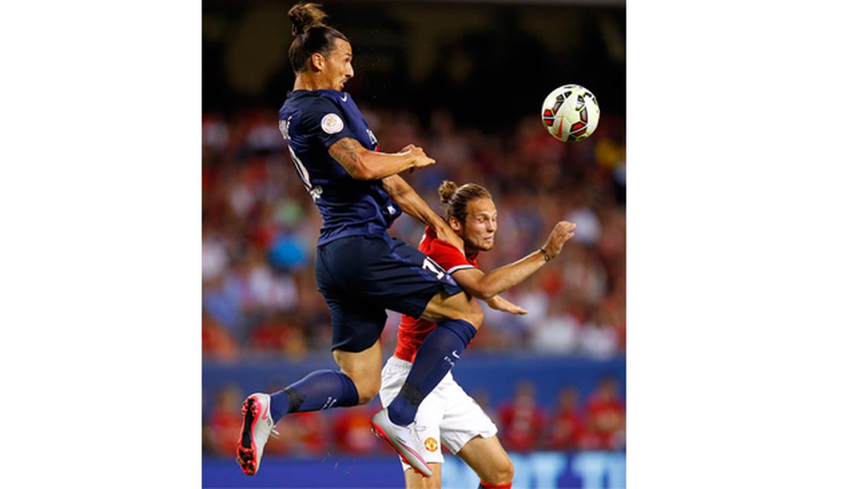 Pemain PSG, Zlatan Ibrahimovic melakukan duel udara dengan pemain Manchester United, Daley Blind pada laga International Champions Cup 2015 di Soldier Field, AS, Kamis (30/7) pagi WIB. (Reuters/Jeff Haynes)