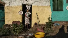 Seorang perempuan berdiri di depan pintu sebuah rumah di Kota Gondar, Ethiopia pada 09 November 2020. (Photo by EDUARDO SOTERAS / AFP)