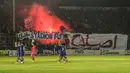 Suporter Arema Indonesia menyalakan flare usai laga semifinal leg pertama Piala Presiden di Stadion Kanjuruhan, Malang, Sabtu (3/10/2015). Arema imbang dengan Sriwijaya FC 1-1. (Bola.com/Kevin Setiawan)