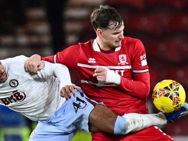 Pemain Aston Villa Jacob Ramsey (kiri) berebut bola dengan pemain Middlesbrough Rav van den Berg pada pertandingan sepak bola putaran ketiga Piala FA di Stadion Riverside, Middlesbrough, Inggris, Sabtu (6/1/2023). (Oli SCARFF/AFP)