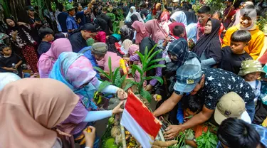 Warga membawa hasil pertanian saat acara budaya sedekah bumi di Lembur Sawah, Mulyaharja, Bogor, Jawa Barat, Minggu (23/7/2023). (merdeka.com/Arie Basuki)