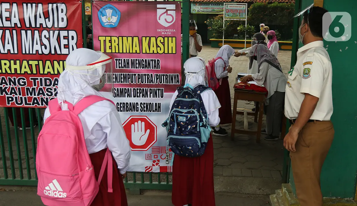 Sejumlah murid  memasuki sekolah  SD Negeri 6, Bekasi, Jawa Barat, Selasa (4/8/2020). Pemerintah setempat memberikan izin kepada enam sekolah untuk melakukan uji coba pembelajaran tatap muka selama satu bulan. (Liputan6.com/Herman Zakharia)