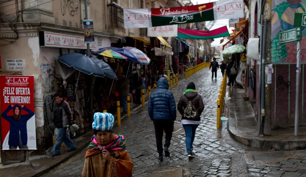 Wanita suku Aymara melintasi jalan di Pasar Penyihir, kota tua La Paz, Bolivia, 10 Juli 2018. Pasar bernama Mercado de las Brujas ini menjual barang-barang aneh dan segala sesuatu yang berhubungan dengan sihir. (AP/Juan Karita)