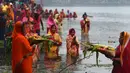 Umat Hindu India membawa sesajen ketika berdoa pada matahari di Kolkata saat Festival Chhath untuk memuja dewa matahari, Selasa (17/11). Dalam festival tersebut, sejumlah umat Hindu berdoa saat matahari terbit dan tenggelam. (AFP PHOTO/Dibyangshu SARKAR)