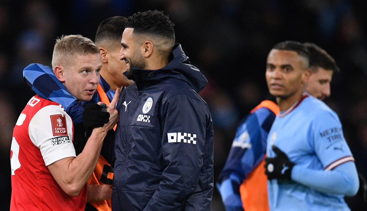 Zinchenko (kiri) juga bercengkrama dengan Ryad Mahrez yang merupakan mantan rekannya waktu sama-sama membela Manchester City. (AFP/Oli Scarff)