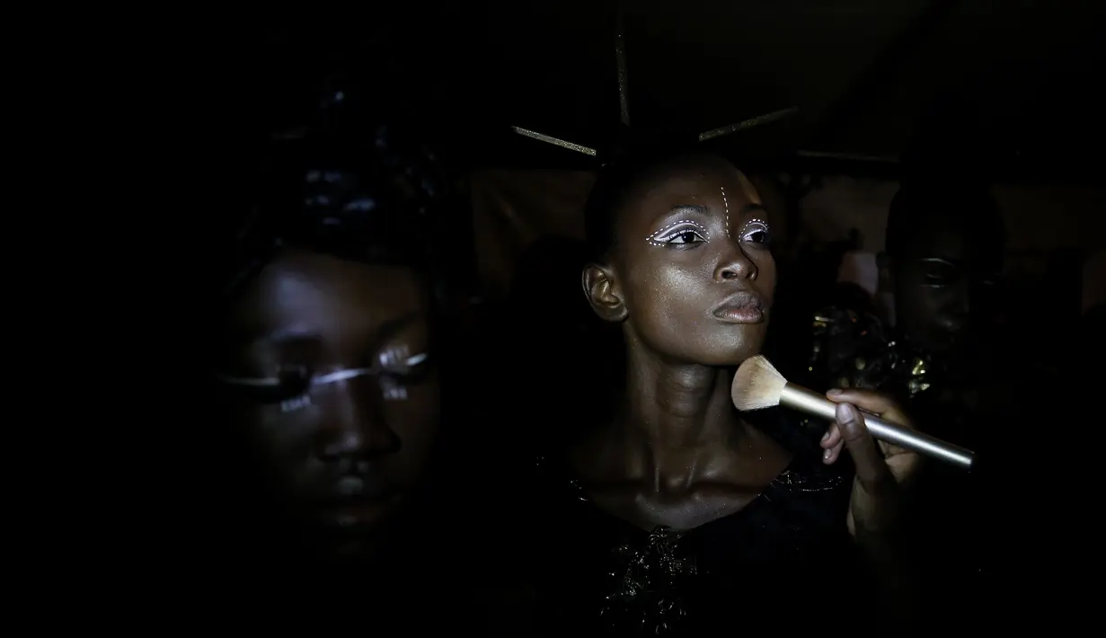 Model saat dirias di belakang panggung Dakar Fashion Week di ibukota Senegal, (30/6). Menurut data Euromonitor dunia fashion di Sub-Sahara Afrika telah berkembang pesat selama dua dekade terakhir. (AP Photo / Finbarr O'Reilly)