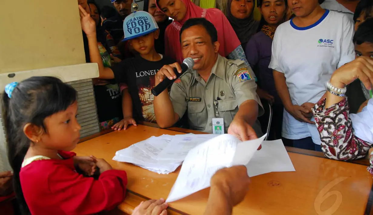 Seorang petugas Kantor Kelurahan Lenteng Agung, Jakarta, tampak melayani warga yang mengurus Kartu Pintar Jakarta (KJP), Rabu (4/6/14). (Liputan6.com/Miftahul Hayat)