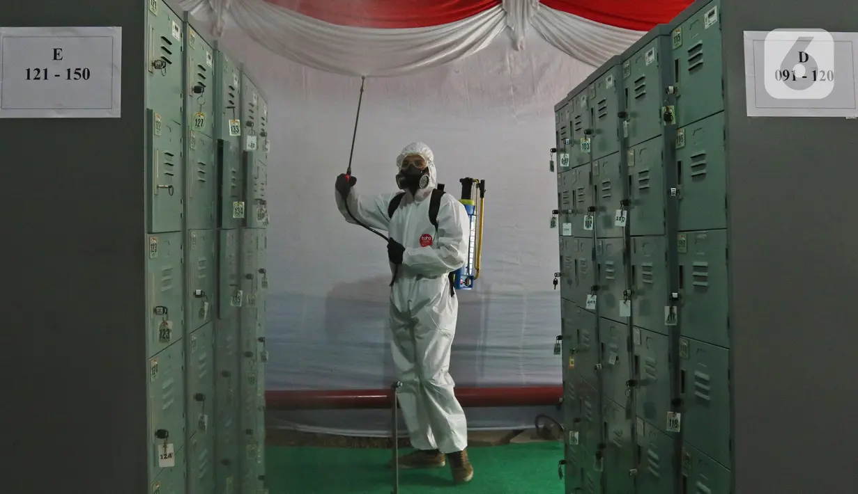 Petugas menyemprotkan disinfektan  di BKN, Jakarta, Kamis (2/9/2021). Sebanyak 800 peserta mengikuti tes yang dibagi dua sesi dan menerapkan protokol kesehatan yang ketat. (Liputan6.com/Herman Zakharia)