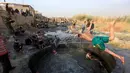Seorang tentara Irak melompat ke kolam belerang di Hammam al-Ali, Mosul, Irak, (9/11). Di tengah perang melawan ISIS, mereka melepaskan penat dan lelah dengan berenang di Kolam belerang. (REUTERS/Alaa Al-Marjani)