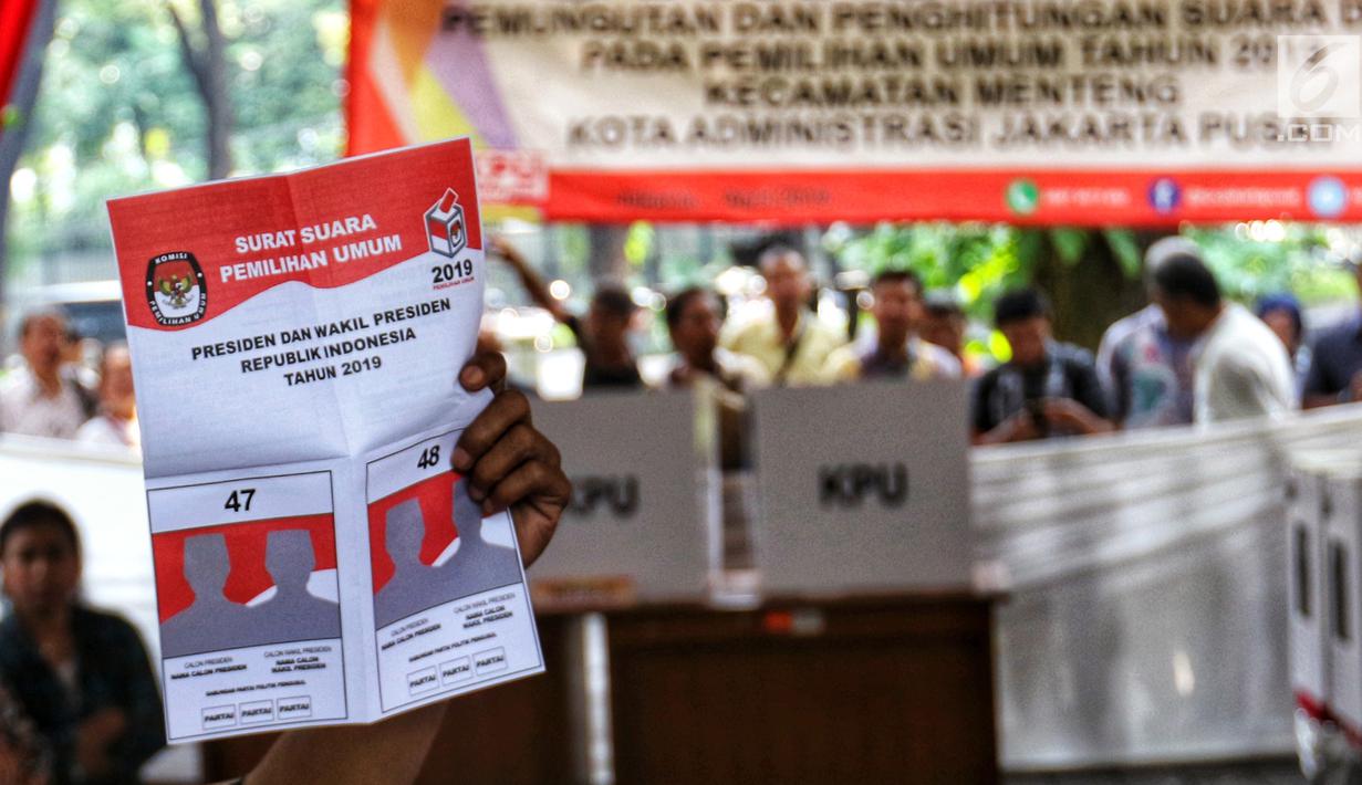 Petugas KPPS memperlihatkan contoh surat suara kepada pemilih saat simulasi pemungutan dan pencoblosan surat suara Pemilu 2019 di Taman Suropati, Jakarta, Rabu (10/4). Simulasi itu untuk meminimalisir kesalahan dan kekurangan saat pencoblosan pemilu pada 17 April nanti. (Liputan6.com/Johan Tallo)
