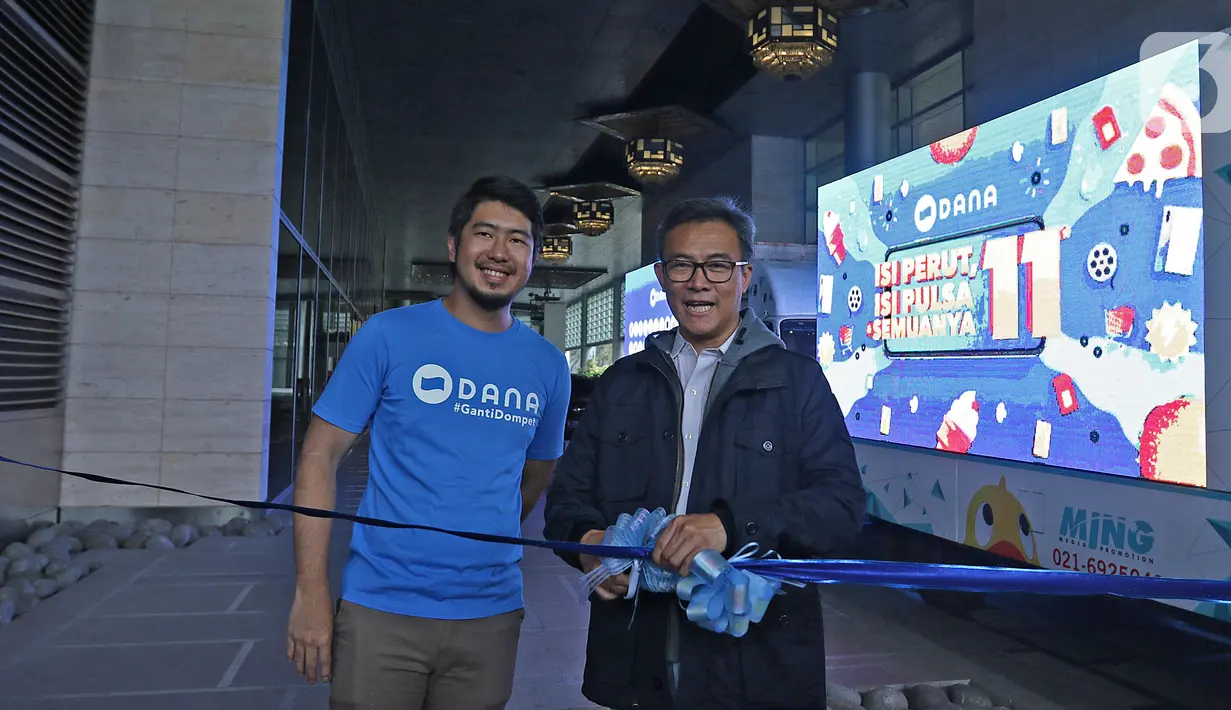Senior Marketing Manager DANA Lim Wimawan Kusuma (kiri) dan Chief Finance Officer DANA Yattha Saputra (kanan) menggunting pita saat melepas konvoi Mobil 11.11 di Jakarta, Kamis (7/11/2019). DANA menggelar konvoi Mobil 11.11 pada 8-11 November 2019. (Liputan6.com/Herman Zakharia)