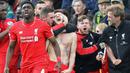 Pemain Liverpool, Adam Lallana (tengah), merayakan gol penentu yang dicetaknya di menit ke-90+2 ke gawang Norwich City dalam laga Liga Inggris di Stadion Carrow Road, Norwich, Sabtu (23/1/2016). Liverpool menang 5-4. (AFP/Lindsey Parnaby)