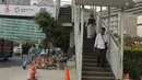 Pejalan kaki menuruni tangga jembatan penyeberangan orang (JPO) di Bundaran HI, Jakarta, Selasa (24/7). Pemprov DKI berencana merobohkan JPO tersebut karena menghalangi pandangan ke Patung Selamat Datang. (Liputan6.com/Arya Manggala)