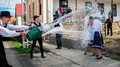 Para pria berkostum rakyat Szekler Bukovina menyiram air ke seorang wanita muda di Ciko, selatan Budapest, Senin (3/4). Tradisi Paskah populer di Hungaria ini dilakukan pada Senin Paskah yang juga dikenal dengan nama Ducking Monday (Tamas Soki/MTI via AP)