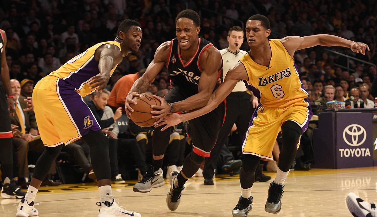 Pemain Toronto Raptors, DeMar DeRozan (tengah) berusaha melewati para pemain Los Angeles Lakers pada lanjutan NBA di  Staples Center, Sabtu (21/11/2015). (Reuters/Mandatory Credit: Kelvin Kuo-USA TODAY Sports)