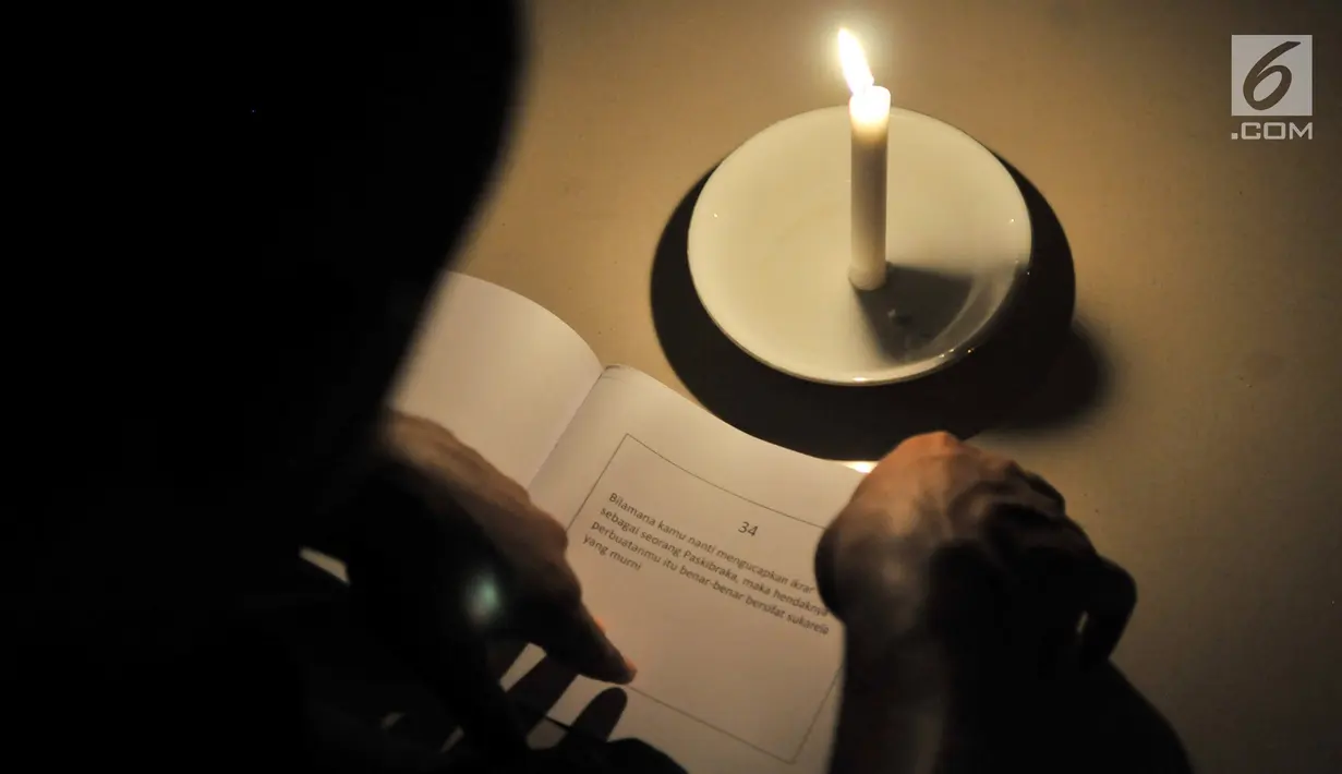 Lilin yang digunakan sebagai penerang selama renungan jiwa di Aula PPPON Cibubur, Jakarta, Minggu (13/8). Cahaya itu digunakan Calon Paskibraka untuk membaca buku renungan, yang mengingatkan mereka akan jasa-jasa para Pahlawan. (Liputan6.com/Yoppy Renato)