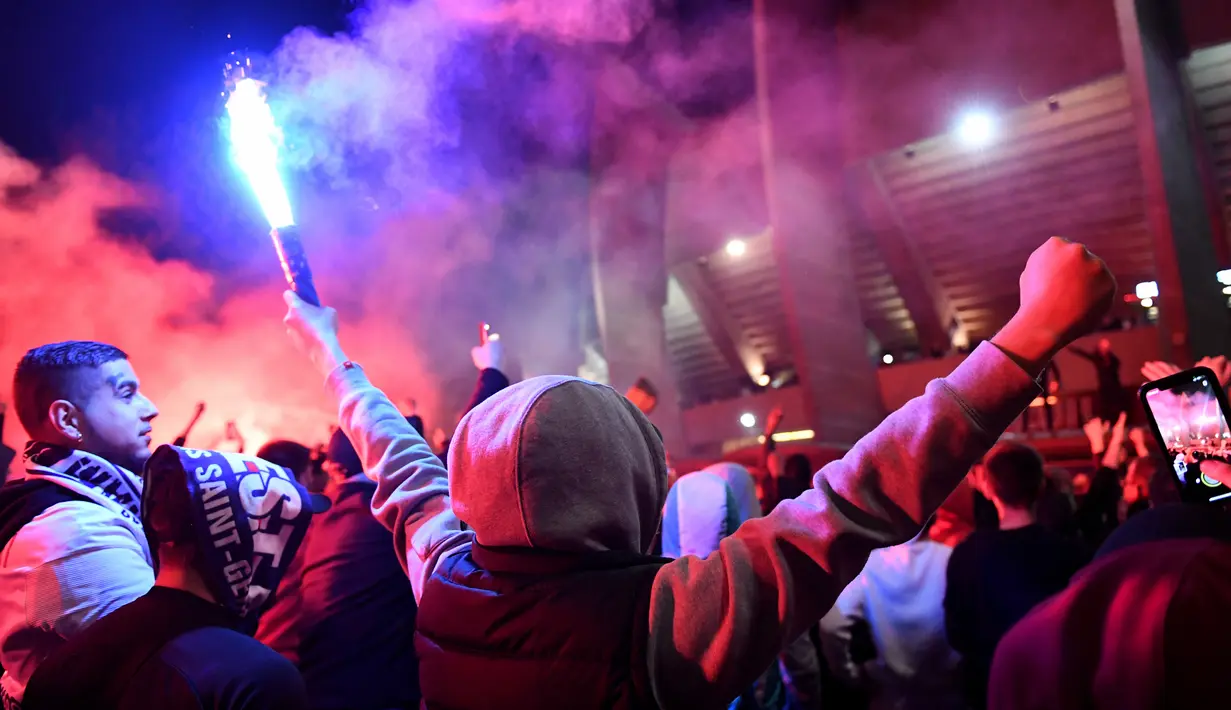<p>Suporter Paris Saint-Germain (PSG) merayakan gelar Ligue 1 Prancis klub mereka pada akhir laga pekan ke-34 Ligue 1 kontra Lens di luar Parc des Princes, Minggu (24/4/2022) dini hari WIB. PSG juarai Liga Prancis untuk ke-10 kali meski ditahan seri Lens 1-1. (JULIEN DE ROSA / AFP)</p>
