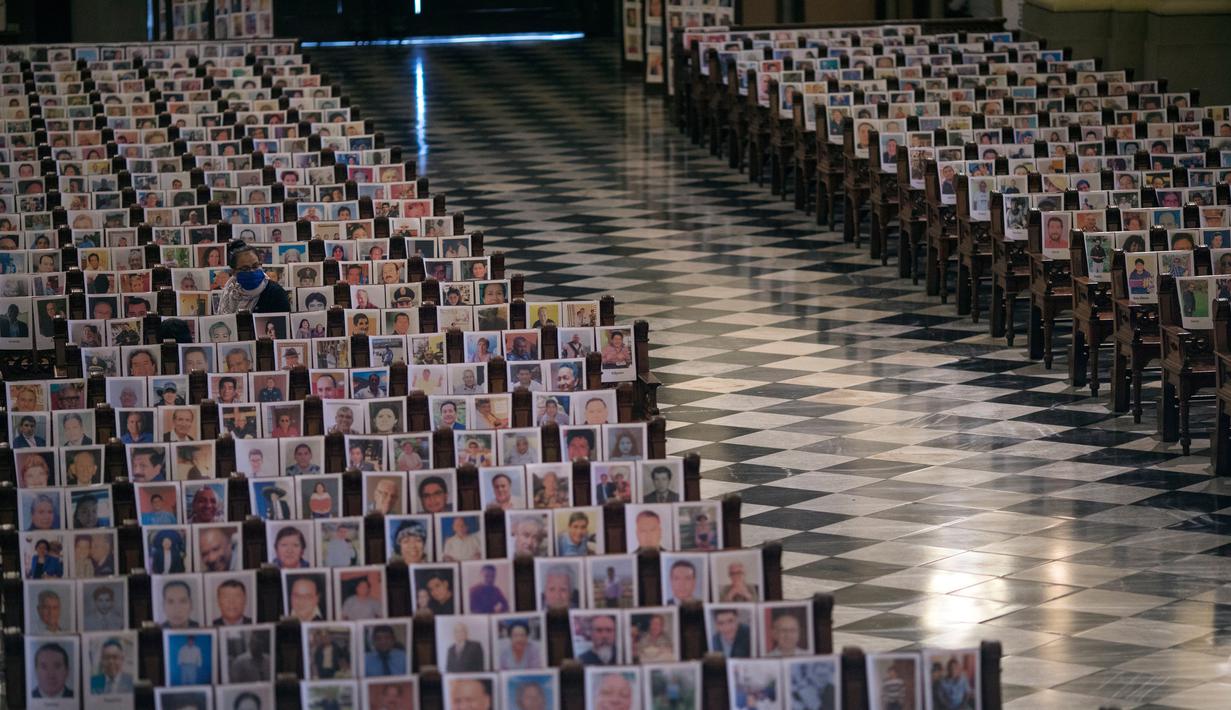 Foto Korban Covid-19 di Katedral Peru: Jemaat duduk di antara potret korban meninggal akibat virus corona di Katedral, di Lima,13 Juni 2020. Misa Minggu di Katedral Lima dihadiri lebih dari 4.000 potret mereka yang telah meninggal dalam pandemi Covid-19 di Peru. (AP/Rodrigo Abd)