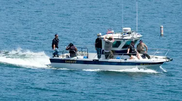 Kedua orang tua Naya Rivera dan anggota sheriff Ventura County terlihat setelah jasad aktris Glee itu ditemukan, di Danau Piru, California, Senin (13/7/2020). Kepolisian wilayah Ventura pada Senin (13/7) pagi mengumumkan telah mengangkat jasad  Naya Rivera dari Danau Piru.  (AP/Ringo H.W. Chiu)