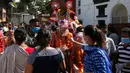Anggota komunitas Newar mengenakan kostum dan masker saat berpartisipasi dalam prosesi 'Gai Jatra', atau festival sapi, di Kathmandu, Nepal, Selasa (4/8/2020). Festival ini untuk meminta keselamatan dan kedamaian bagi orang yang mereka cintai yang telah meninggal. (AP Photo/Niranjan Shrestha)