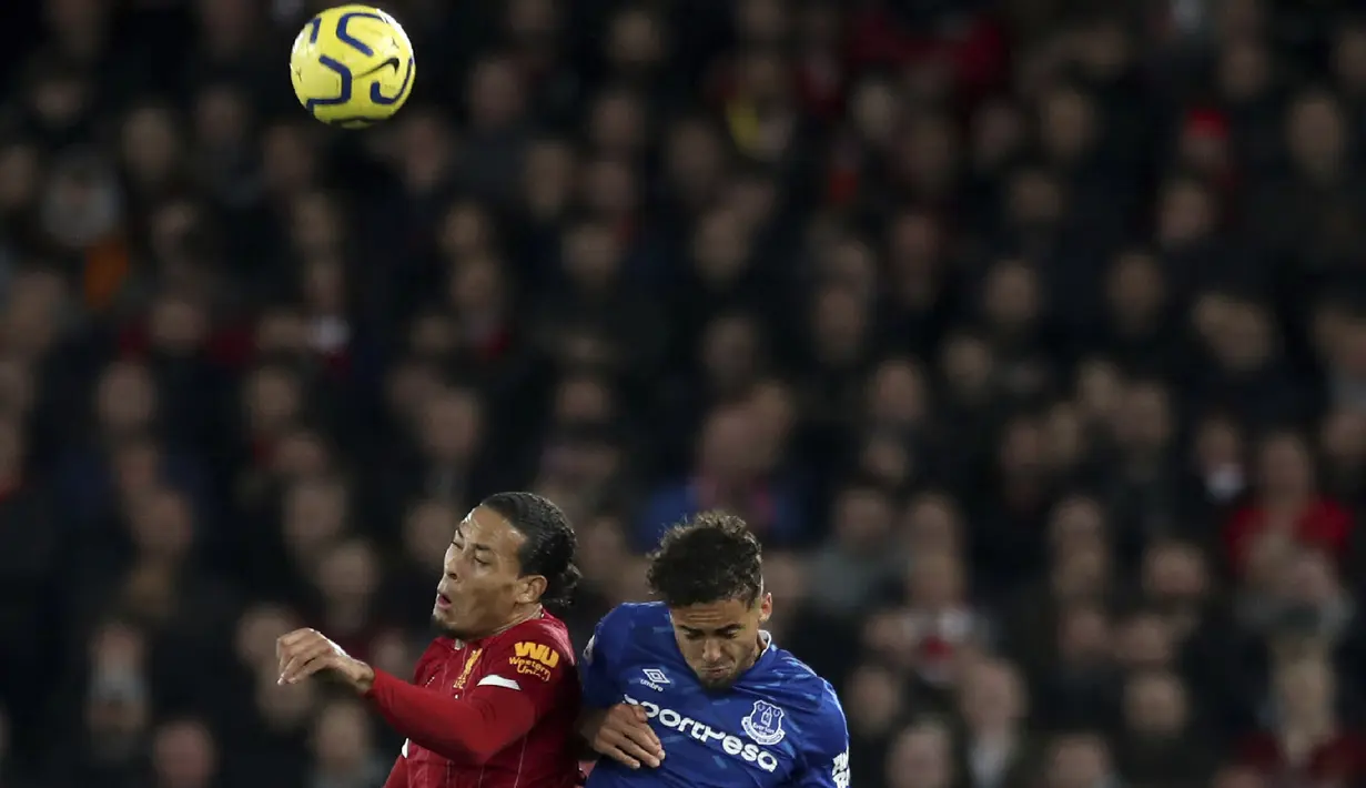 Bek Liverpool, Virgil van Dijk (kiri) berebut bola udara dengan pemain Everrton, Dominic Calvert-Lewin  pada pertandingan lanjutan Liga Inggris di Stadion Anfield, Rabu (4/12/2019). Liverpool menang telak 5-2 atas Everton. (AP Photo/Jon Super)