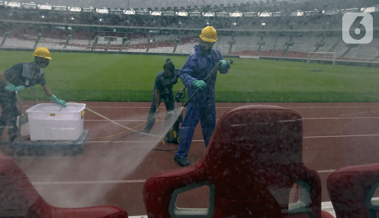 Petugas menyemprotkan cairan disinfektan ke bench pemain di Stadion Utama Gelora Bung Karno (SUGBK), Jakarta, Kamis (26/3/2020). Penyemprotan dilakukan guna mencegah penyebaran virus corona COVID-19 di seluruh venue kawasan SUGBK. (merdeka.com/Imam Buhori)