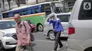 Seorang wanita menyebrang selama gelombang panas di Jakarta, Selasa (22/10/2019).  BMKG memprediksi wilayah Indonesia akan mengalami panas selama kurang lebih satu minggu ini. Hal ini dikarenakan matahari yang berada dekat dengan jalur khatulistiwa. (Liputan6.com/Faizal Fanani)
