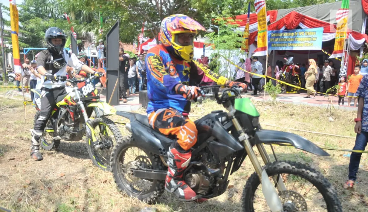 Warga menyaksikan para trabas-er balapan di TPS 6  Kelurahan Panggung Lor,  Kota Semarang,  Rabu (17/4). TPS tersebut mengangkat tema trail trabas agar menghibur warga dengan aksi balapan saat melakukan hak pilih di pemilu 2019. (Liputan6.com/Gholib)