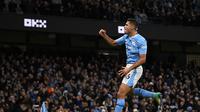 Gelandang Man City, Rodri, merayakan gol yang dicetaknya ke gawang Sheffield United dalam laga pekan ke-20 Liga Inggris 2023/2024 di Etihad Stadium, Sabtu (30/12/2023) malam WIB. Man City menang 2-0 dalam laga ini. (Oli SCARFF / AFP)