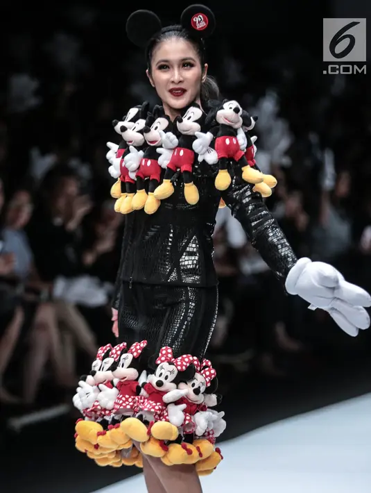 Artis Sandra Dewi memperagakan busana kolaborasi antara Disney dan Matahari pada Jakarta Fashion Week 2019 di Senayan City, Selasa (23/10). Dalam penampilannya, Sandra Dewi mengenakan busana dengan ornamen boneka Mickey Mouse. (Liputan6.com/Faizal Fanani)