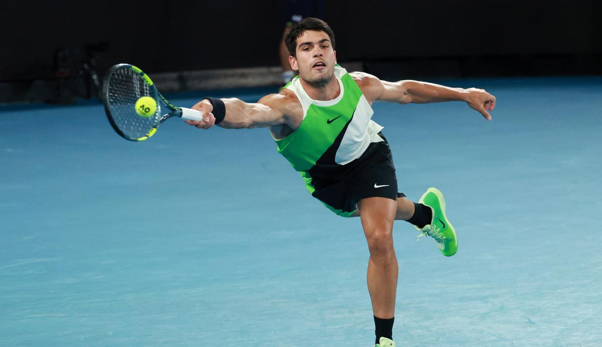 Aksi Carlos Alcaraz pada partai final Australian Open 2026 melawan Novak Djokovic dalam laga sengit yang dilangsungkan di Melbourne Park pada (1/2/2026) sore WIB. (AFP/David Gray)