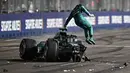 Pembalap Aston Martin, Lance Stroll melompat ke luar dari mobilnya setelah tabrakan pada sesi kualifikasi Formula 1 GP Singapura 2023 di Marina Bay Street Circuit, Singapura, 16 September 2023. (AFP/Lillian Suwanrumpha)