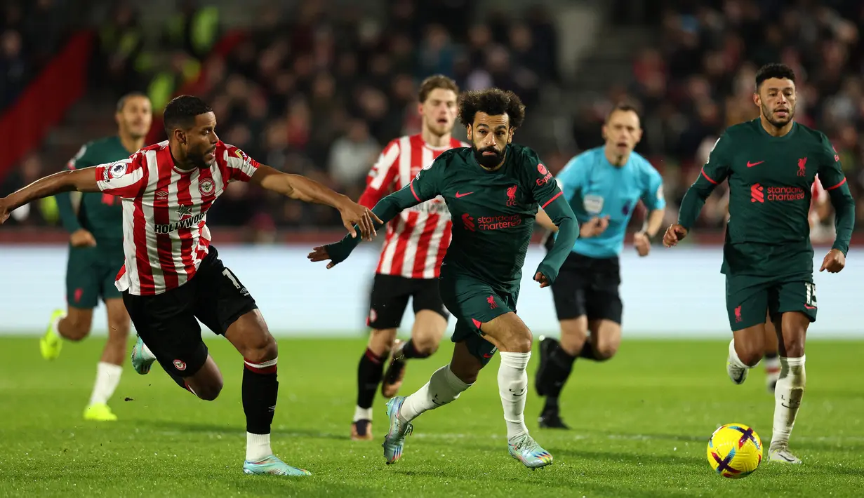 Bek Brentford, Mathias Jorgensen (kiri) berusaha mengadang laju striker Liverpool, Mohamed Salah pada laga Liga Inggris 2022/2023 di Gtech Community Stadium, London (2/1/2023). Mathias Jorgensen yang akrab disapa Zanka ini didatangkan Brentford dari Fenerbahce pada awal musim 2021/2022 dengan status bebas transfer. Musim 2022/2023 ini ia telah tampil dalam 13 laga di Liga Inggris. (AFP/Adrian Dennis)