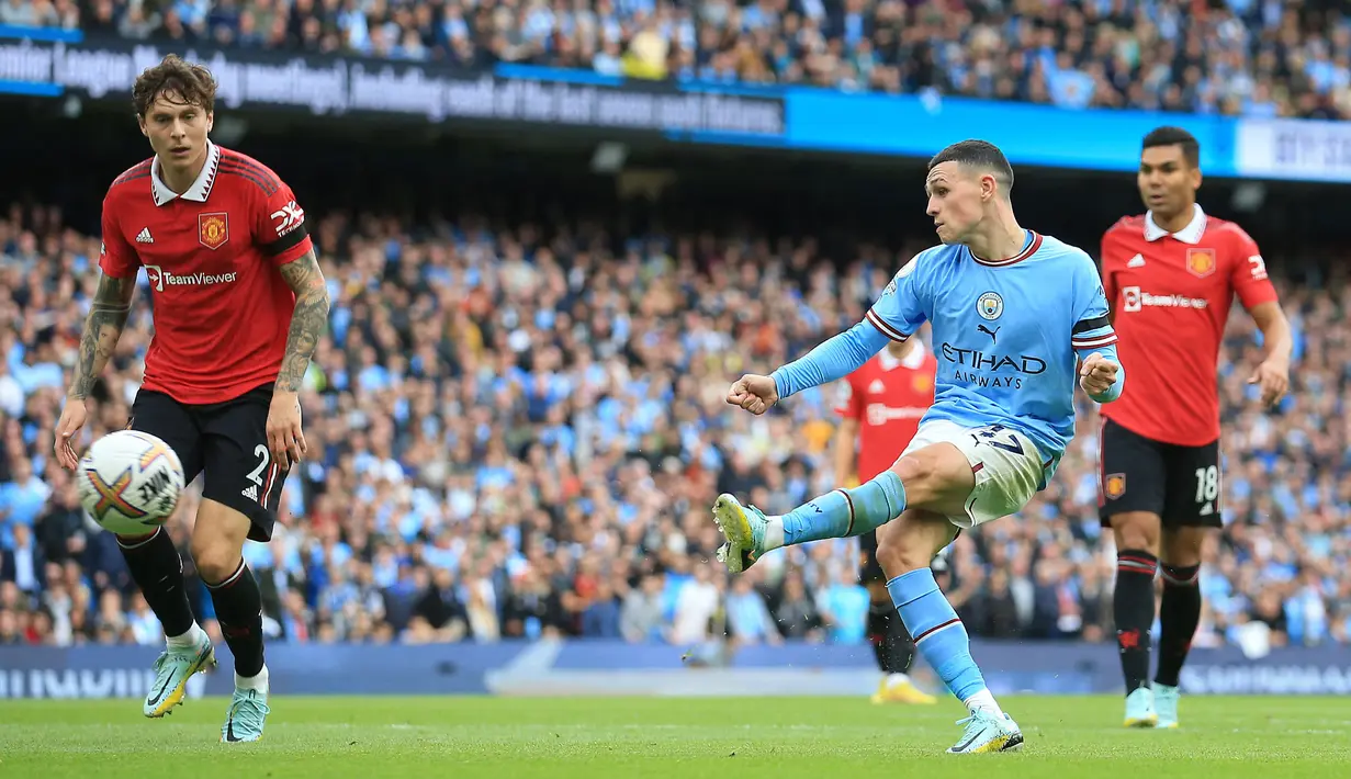 Phil Foden yang kini tengah menjalani musim ke-7 bersama Manchester City menjadi pemain Inggris kedua yang mampu mencetak hattrick ke gawang Manchester United di era Premier League. Momen itu terjadi pada pekan ke-9 EPL musim 2022/2023 saat Man City yang berstatus tuan rumah menang 6-3 atas MU (2/10/2022). Tiga gol ke gawang David De Gea dicetak pada menit ke-8, 44 dan 73. Selain dirinya, Erling Haaland juga mencetak hattrick dalam laga tersebut. (AFP/Lindsey Parnaby)