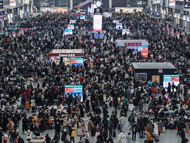Penumpang menunggu di stasiun kereta api Hongqiao di Shanghai (20/1/2023). Migrasi tahunan dimulai dengan jutaan orang kembali ke kampung halaman mereka untuk perayaan Tahun Baru Imlek. (AFP/Hector Retamal)