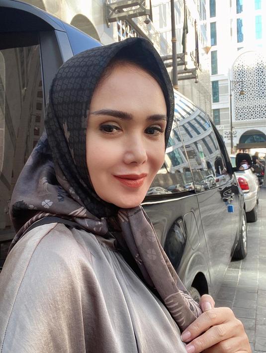 Yuni Shara selfie dengan latar belakang gedung dan mobil mewah. (Foto: Instagram/ yunishara36)