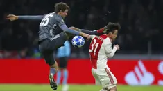 Gelandang Bayern Munchen, Thomas Mueller, menendang kepala bek Ajax Amsterdam, Nicolas Tagliafico, pada laga Liga Champions di Johan Cruyff Arena, Amsterdam, Rabu (12/12). Kedua tim bermain imbang 3-3. (AP/Peter Dejong)