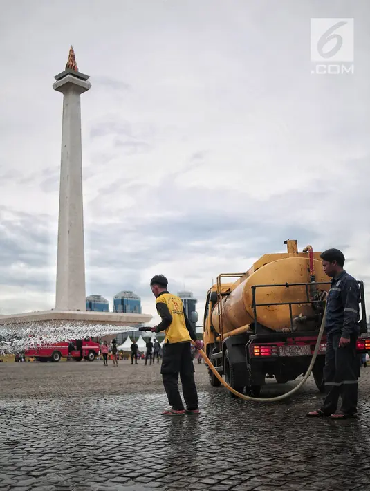 Petugas kebersihan membersihkan sisa sampah usai perayaan Tahun Baru 2019 di Monas, Jakarta, Selasa (1/1). Sebagian besar warga menuruti imbauan Pemprov DKI Jakarta untuk merayakan pergantian tahun secara sederhana. (Liputan6.com/Faizal Fanani)