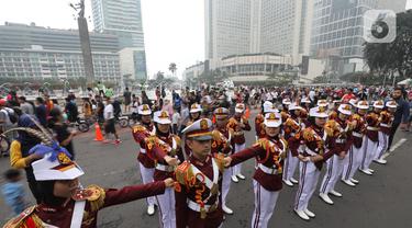 Polisi Cilik melakukan aksi baris-berbaris  saat CFD di kawasan Budaran HI, Jakarta, Minggu (3/7/2022). Aksi ini dalam rangka memeriahkan HUT ke-76 Bhayangkara. (Liputan6.com/Angga Yuniar)