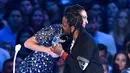 Aktris Gal Gadot berpelukan dengan Kendrick Lamar setelah memberi penghargaan pada MTV Video Music Awards (VMA) 2017 di Inglewood, California, AS (27/8). (Photo by Chris Pizzello/Invision/AP)