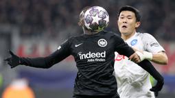 Pemain Eintracht Frankfurt, Randal Kolo Muani (kiri) berebut bola dengan pemain Napoli, Min-jae Kim pada laga leg pertama 16 besar Liga Champions 2022/2023 yang berlangsung di Deutsche Bank Park, Rabu (22/2/2023) WIB. (AFP/Daniel Roland)