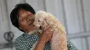Yang Xiaoyun bermain dengan seekor anjing di tempat penampungannya di Tianjin, China, Rabu (8/7). Yang Xiaoyun dikabarkan telah mengeluarkan uang sebesar 48.248 USD untuk menyelamatkan 500 anjing dari toko daging anjing (REUTERS/Kim Kyung-Hoon)