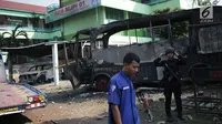 Pasukan Brimob bersiaga dekat bangkai sebuah bus yang terbakar di sekitar asrama Brimob Jalan KS Tubun, Petamburan, Jakarta Barat, Rabu (22/5/2019). Diketahui kerusuhan terjadi di lokasi tersebut, buntut demo depan gedung Bawaslu yang berujung ricuh. (Liputan6.com/Faizal Fanani)